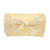 Cable knit bow in soft yellow
